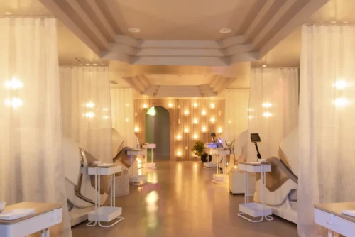 Modern dental clinic with warm lighting and sleek white chairs.