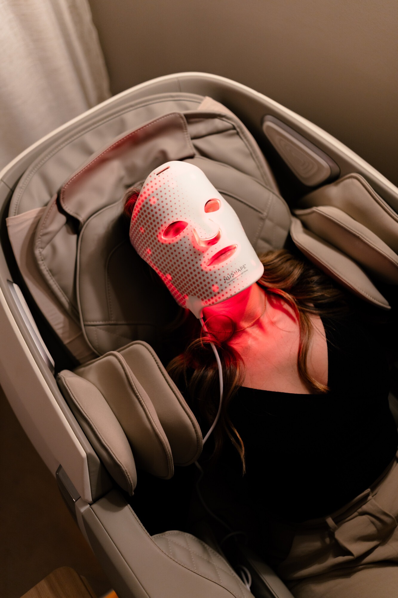 Red light therapy facial mask at Unwind Massage Lounge Dallas